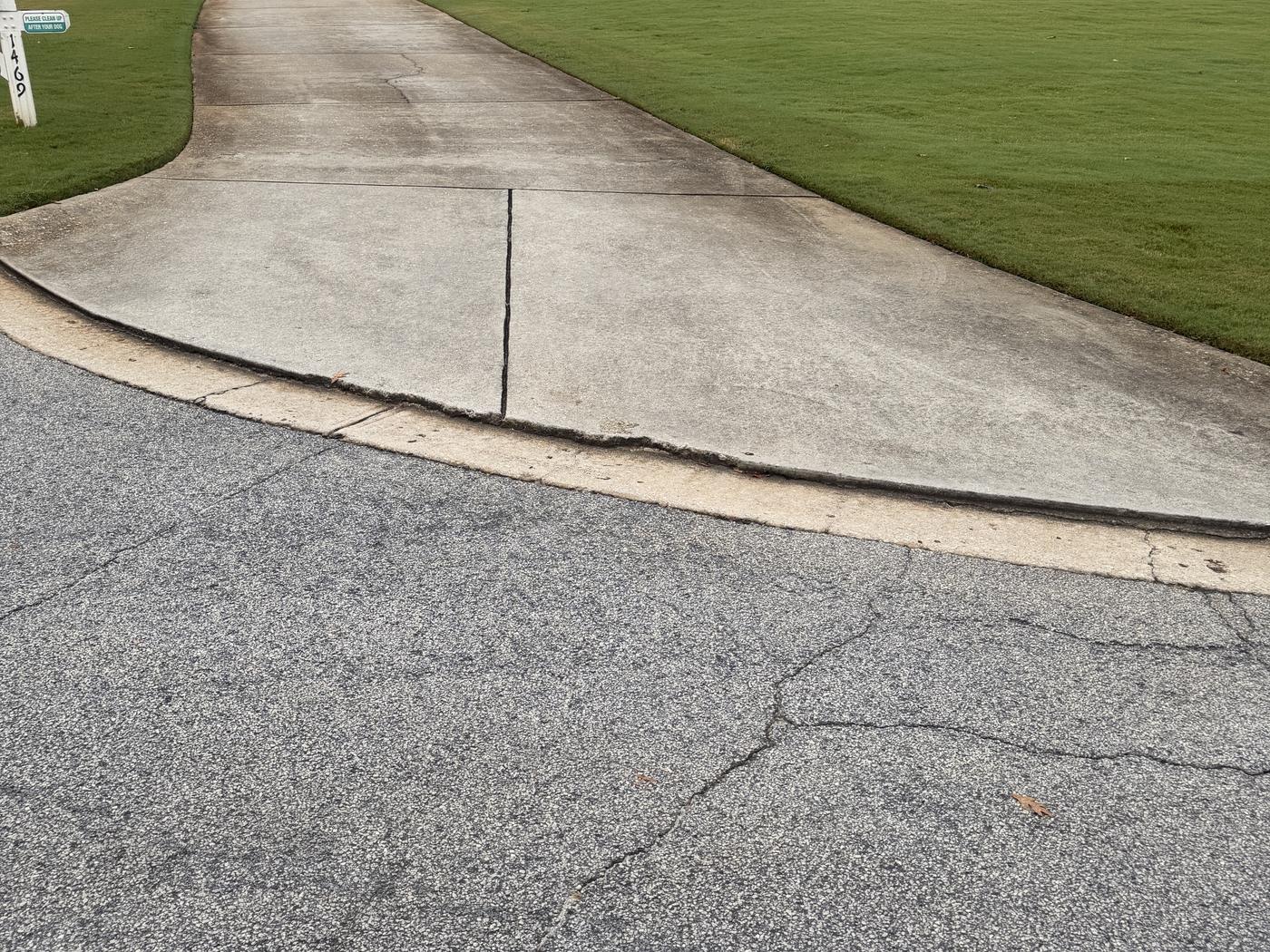 Concrete driveway in Loganville, GA before and after pressure washing, before