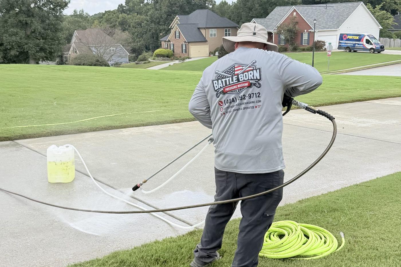 Nick, owner of Battle Born Pressure Washing, pressure washing a front walk in Loganville, GA